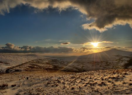 Snow on the mountains with direct sunlightの写真素材