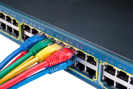Bunch of Colored network cables connected to a switch isolated on white background. Top view 