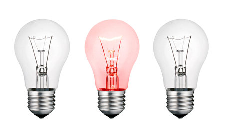 Red Hot Concept Idea - Two White and One Red Lightbulb Isolated on White Backgroundの写真素材