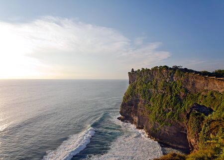 Sunset at Uluwatu Temple on top of big cliffsの写真素材
