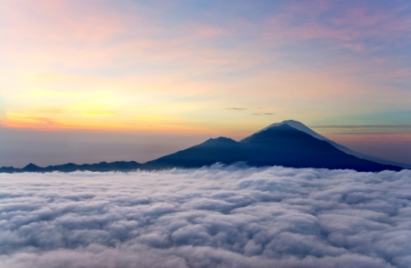Sunrise above clouds with a mountain volcano view  Mt  Batur Bali Indonesiaの写真素材
