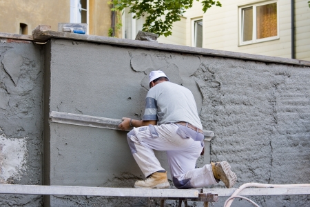Plasterer plastered an old exterior wall.の写真素材