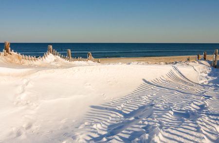Snow covers part of the beach at the Jersey Shore.の写真素材