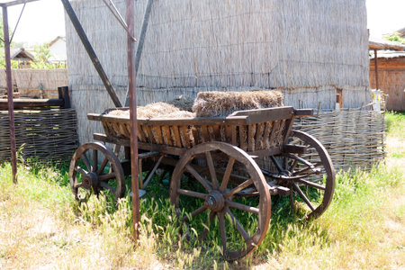 an old cart with hay bales