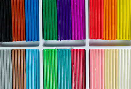 Colored plasticine in a box on a white background close upの写真素材