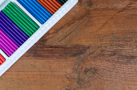 Colorful crayons in a box on a wooden background.の写真素材