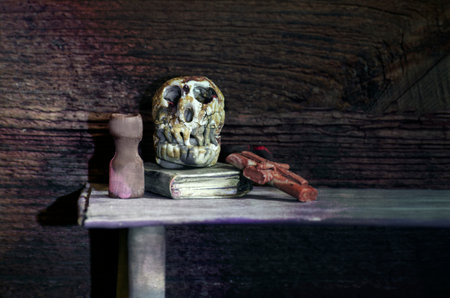 Still life with a stack of old books and a skull on a shelf