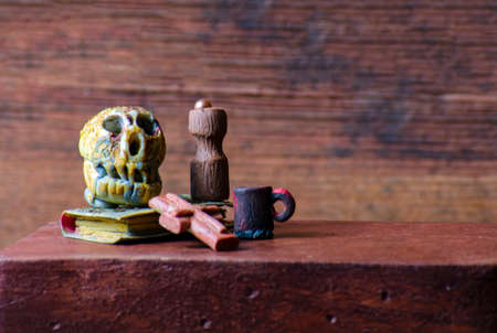 Halloween decoration with skull, candle and candlestick on wooden backgroundの写真素材