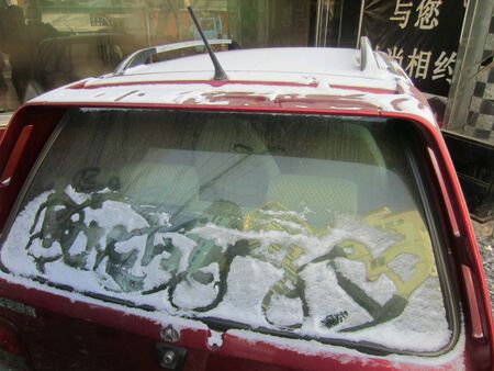 A red car covered in snowの素材