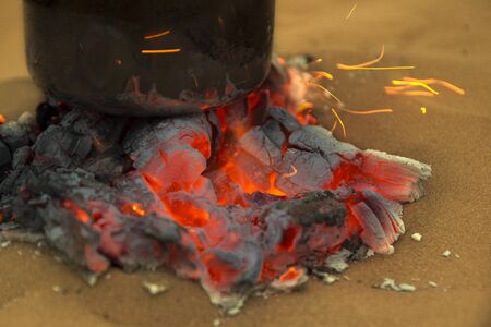 Close-up of burning charcoal with teapot on itの写真素材