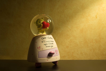 Snow Globe with teddy bear holding heart insideの写真素材