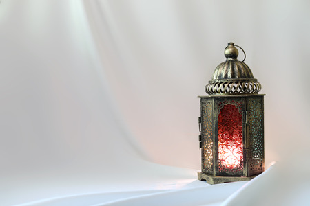 Ancient colored lantern on white satinの写真素材