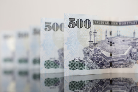 aligned Saudi Notes on a dark glassの写真素材