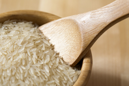 Close-up Rice grain in a wooden bowlの写真素材
