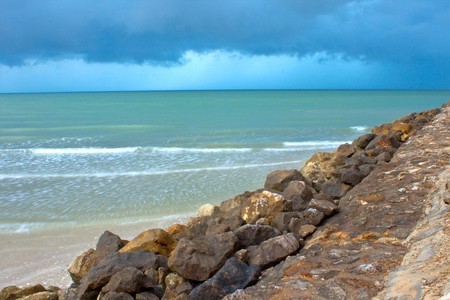 Rocky shore against wave and windの写真素材
