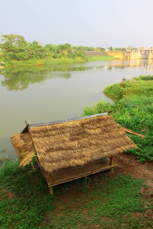Bamboo hut on riverside and reservoirの写真素材