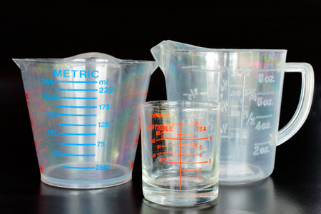 Measuring cups on the black background