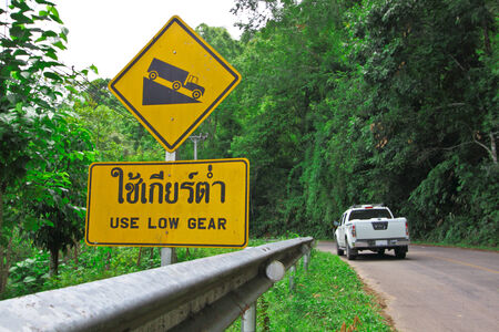 Warning board for use low gear when down hillの写真素材