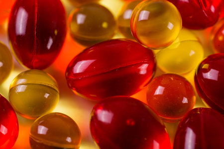 yellow medical capsules on a mirror surface picture with depth of field, macroの写真素材