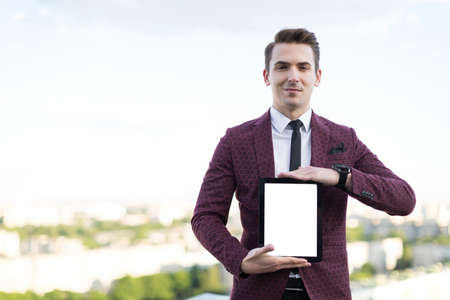 young man with a tablet in his handsの写真素材