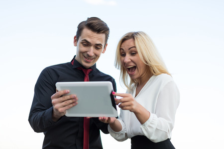 Young office workers watching tablets on the background the cityの写真素材