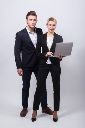 two businessmen the man and woman with a laptop in hand on a white background.の写真素材