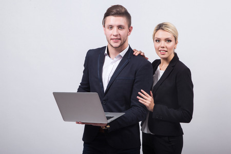 two businessmen the man and woman with a laptop in hand on a white background.の写真素材