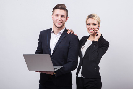 two businessmen the man and woman with a laptop in hand on a white background.の写真素材