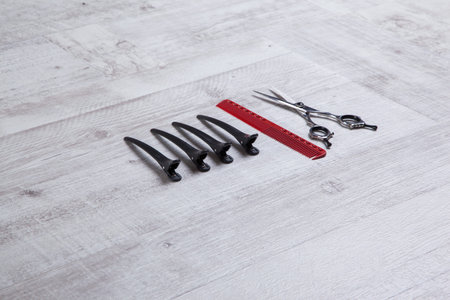 professional barber scissors, tools for cutting, shot with depth of field on light textured...