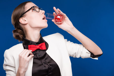 girl with a vial in his hand and a red butterfly on her neck on a blue background