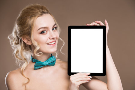 young girl with the tablet on a beige backgroundの写真素材