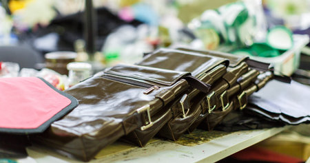 brown mans leather handbags in the manufacturing process. close-up photo