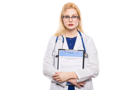 Portrait of female doctor in white coat and glasses wear stethoscope and hold clip pad with medical...