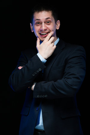 Young smiling business man in black suit standing in office mature handsome confident successful sophisticated stylish classic smart elegant modernの写真素材