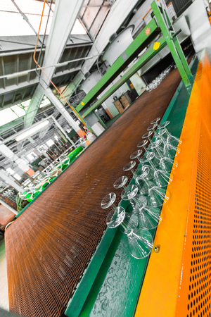 Glass producing at factory stemware in a rowの写真素材