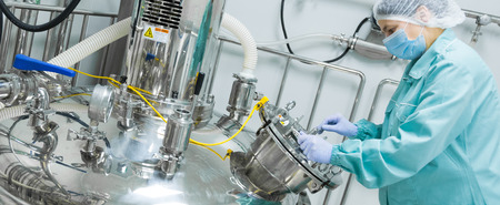 Pharmaceutical technician in sterile environment at pharmacy industryの写真素材