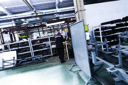 One working day of modern automatic bus trolleybus car production with unfinished cars workers in protective uniform in factory background automobile engineeringの写真素材