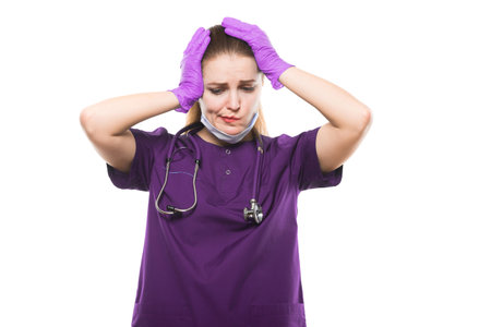 Portrait of young attractive caucasian brunette friendly woman doctor standing in office looking in camera in sterile clothes tired disapponted stressed confusedの写真素材