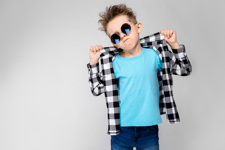 Charming happy child on gray background, hair is upの写真素材