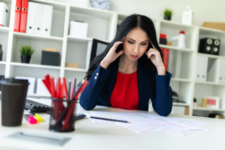 Portrait of a young girl in a suit. Beautiful girl is working in the office.の写真素材