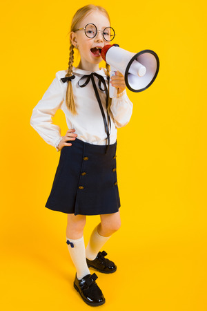 Portrait of a beautiful girl in a white blouse and black skirt.の写真素材