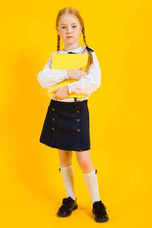 Portrait of a beautiful girl in a white blouse and black skirt.の写真素材