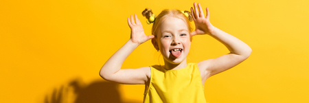 Portrait of a beautiful girl in a yellow blouse and blue jeans.の写真素材
