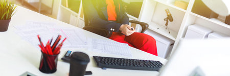 Portrait of a young girl in a suit. Beautiful girl is working in the office.