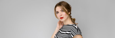 Portrait of beautiful caucasian friendly positive funny woman standing in studio looking in camera...