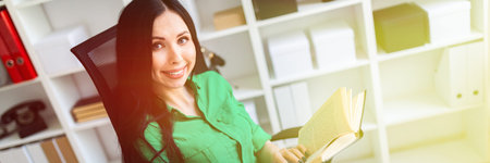 Beautiful girl in green blouse and white pants running in the office. photo with depth of field.