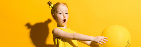 Portrait of a beautiful girl in a yellow blouse and blue jeans.の写真素材