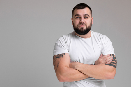 Portrait of a brutal man standing in the Studio on a white background. closeup of a bodybuilder. The concept of sport. Concept of educationの写真素材