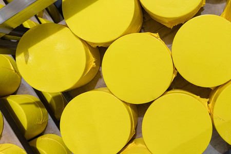 Cheese-making factory background with big heads of cheeseの写真素材