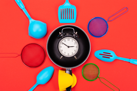 Close up picture of group of kitchen utensils on red backgroundの写真素材